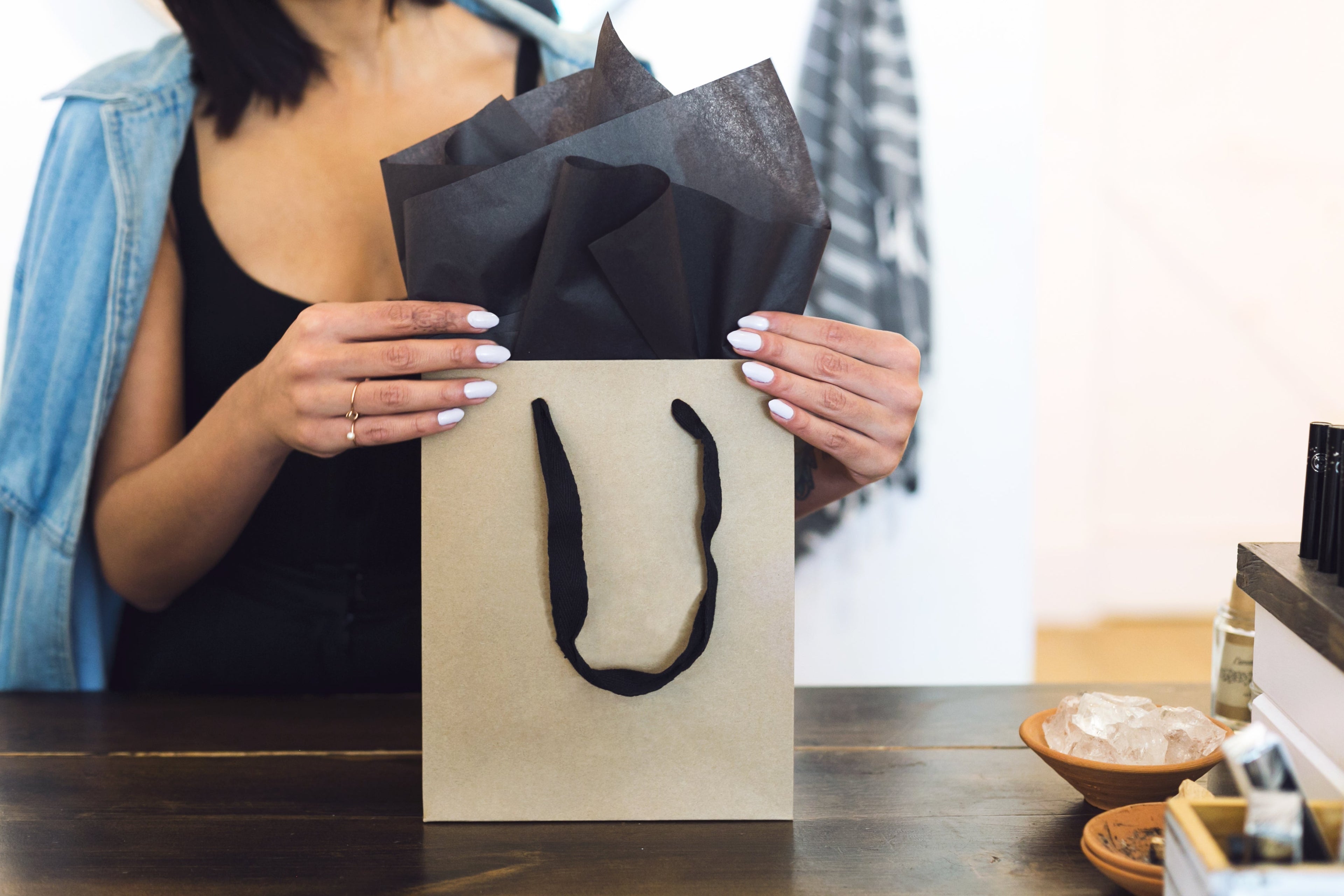 Woman holding shopping bag for staff product picks