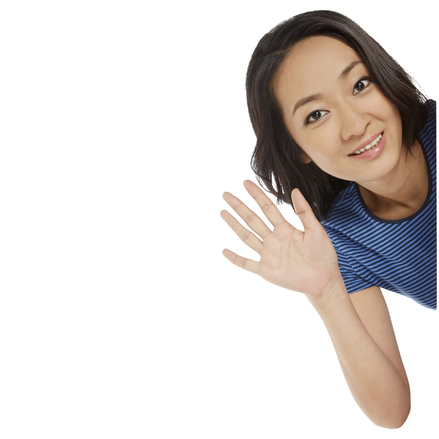 Woman waving to say hello with a smile on a white background