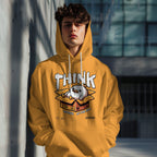 Person wearing a yellow hoodie with a graphic design and text outdoors.