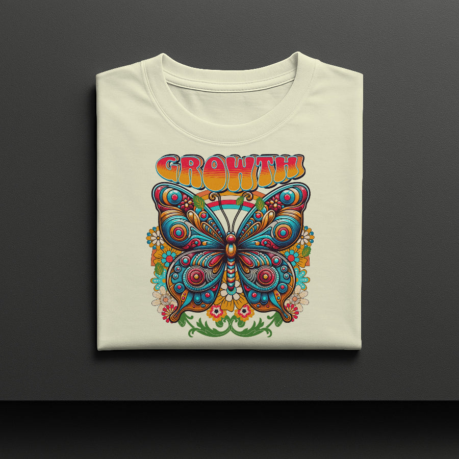 Folded t-shirt with a colorful butterfly design and 'GROWTH' text on a dark background
