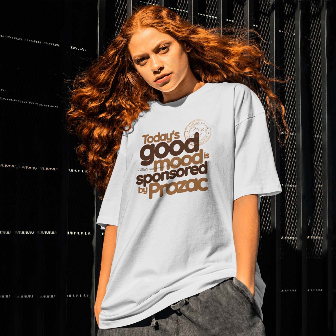 Person wearing a t-shirt with text in front of a black background