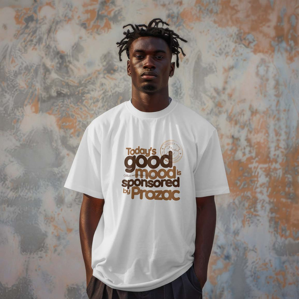 Person wearing a white t-shirt with text in front of a textured wall
