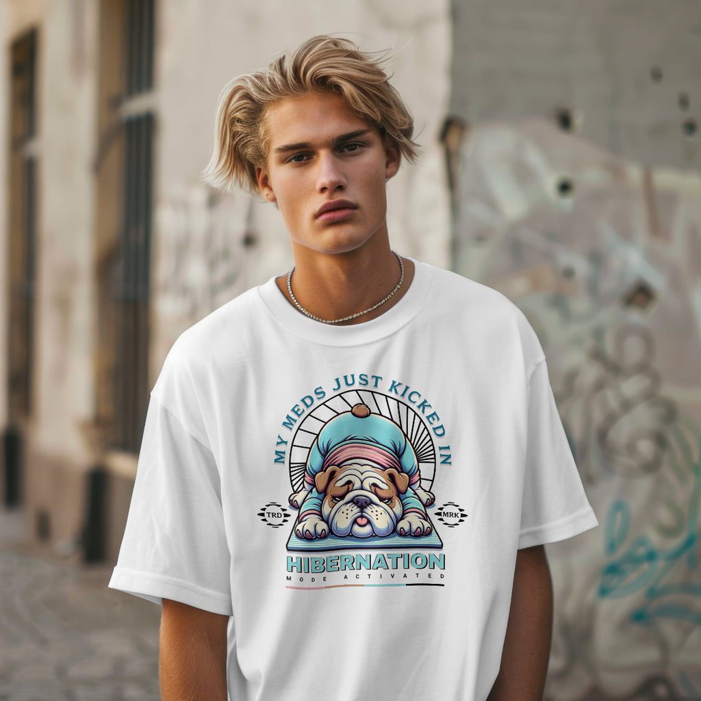 Person wearing a white t-shirt with a graphic design and text, standing against an urban background.