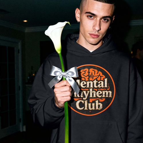 Person wearing a hoodie with 'Mental Rhyme Club' text, holding a white flower with a silver bow.