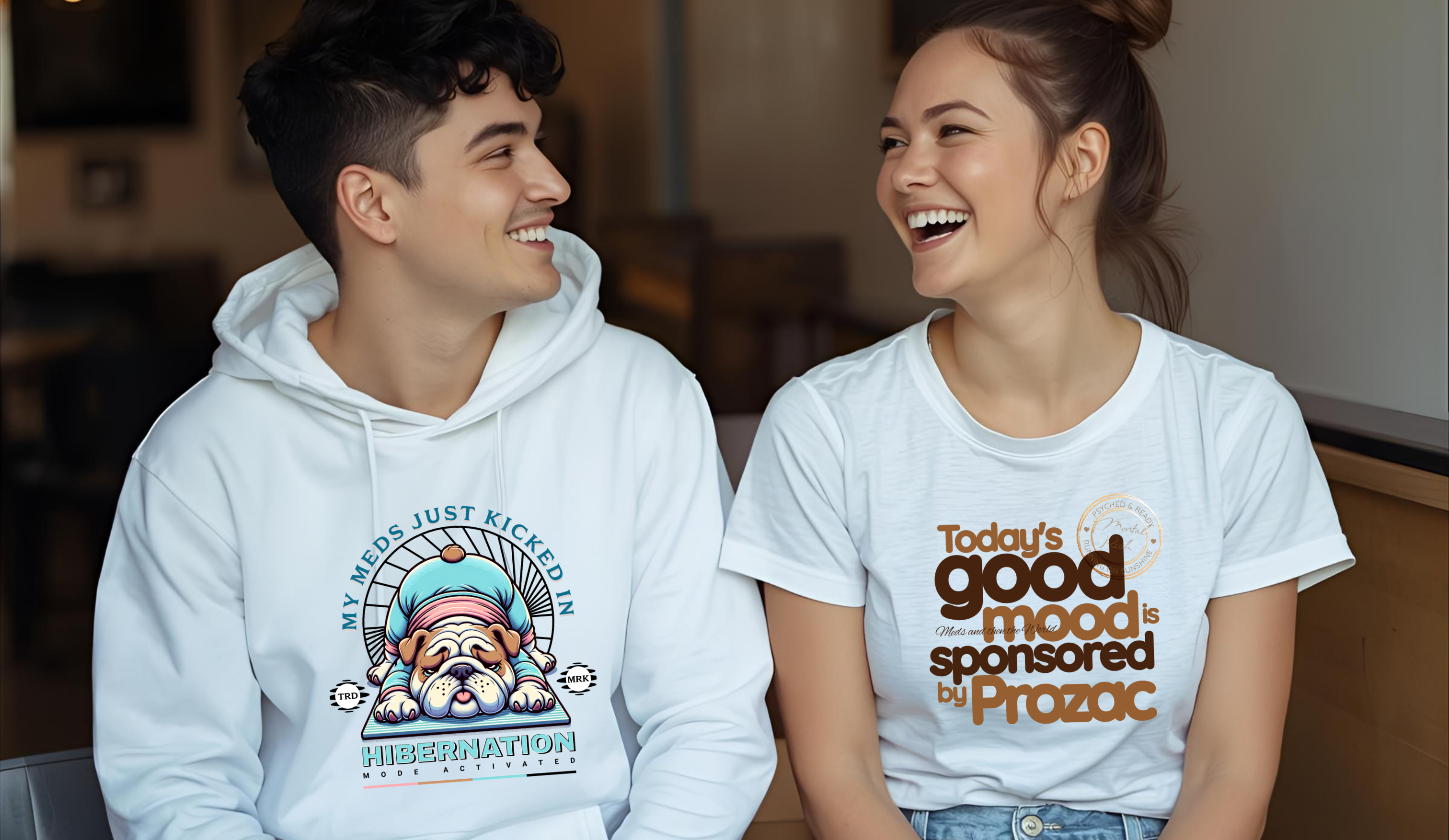 Two people wearing hoodies and t-shirts with humorous text and graphics.