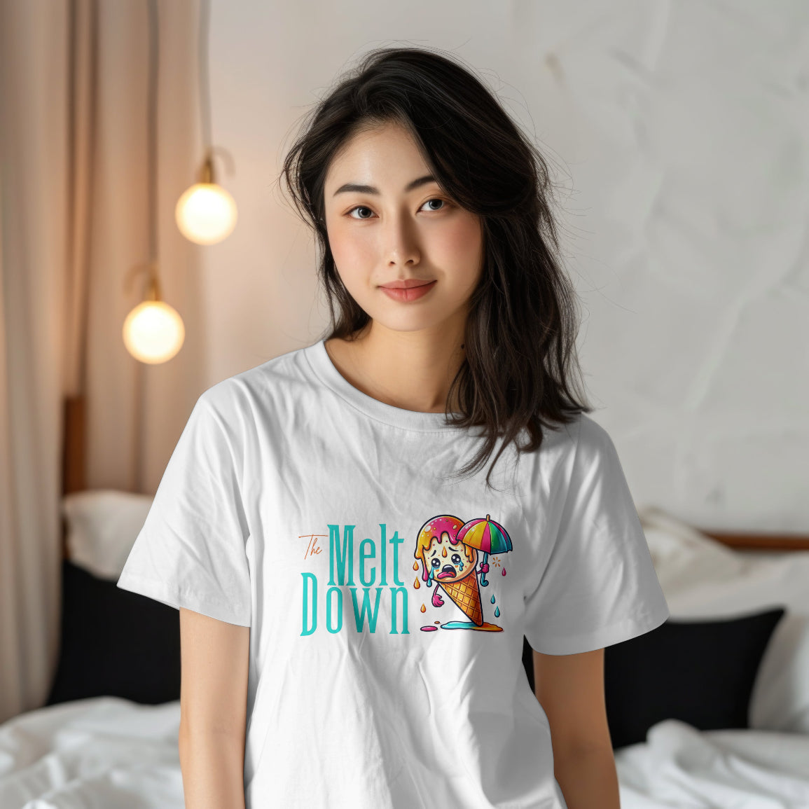 Person wearing a white t-shirt with a colorful graphic and text in a bedroom setting