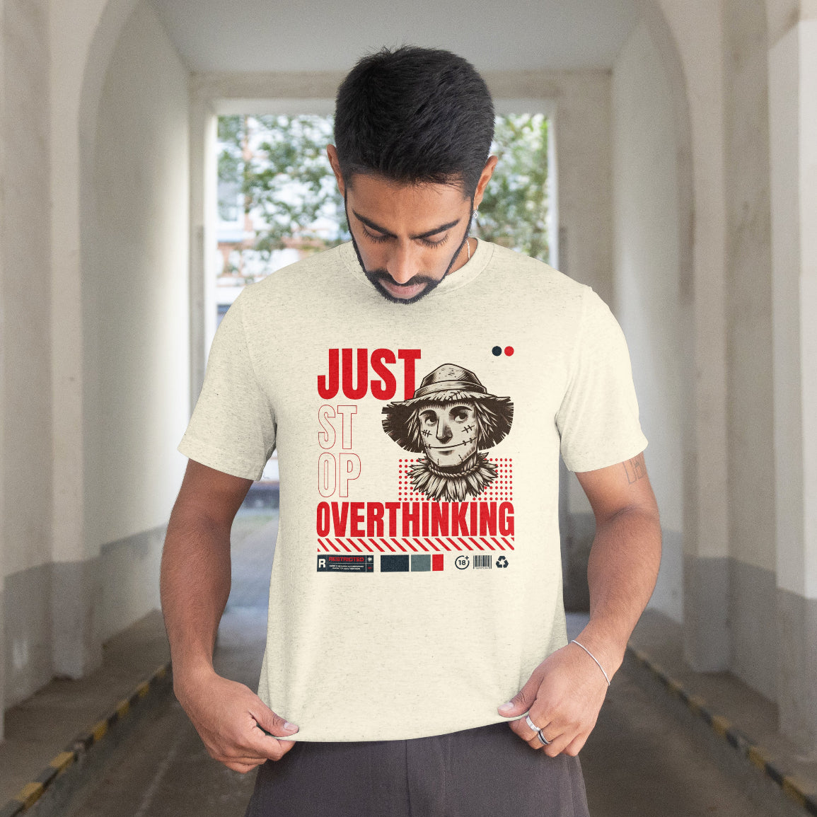 Man wearing a t-shirt with a graphic design and text in an outdoor setting