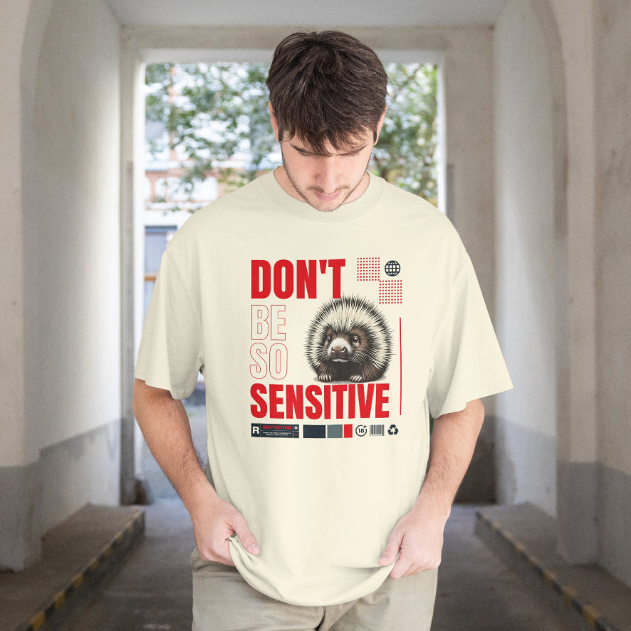 Person wearing a t-shirt with a graphic and text in an indoor setting