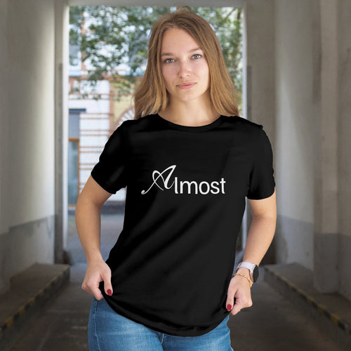 Person wearing a black t-shirt with 'Almost' text in an indoor setting