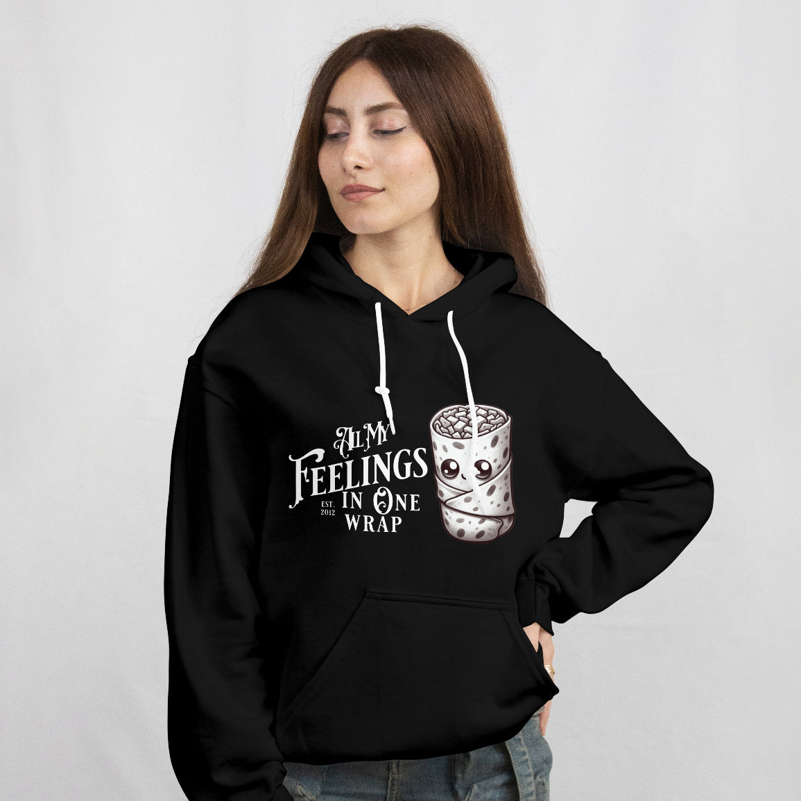 Young woman wearing a black hoodie with a graphic design on a plain background
