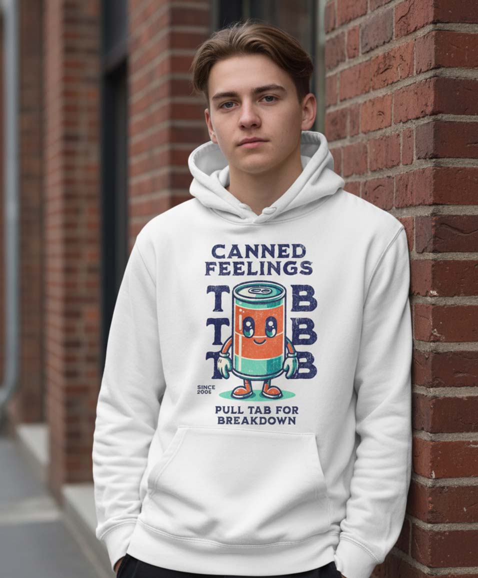 Person wearing a hoodie with a humorous graphic design against a brick wall.
