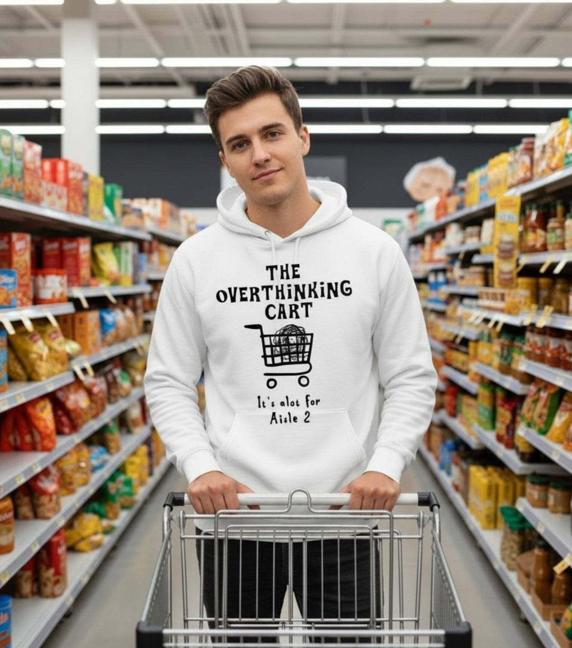 Young man wearing a hoodie with text and graphic of a shopping cart in a supermarket aisle