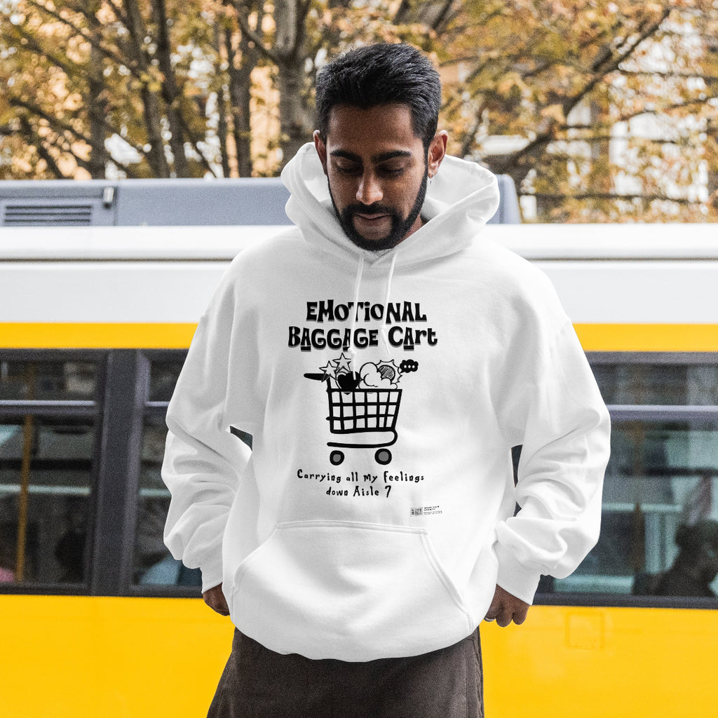 Person wearing a white hoodie with text and graphics, standing in front of a yellow bus.