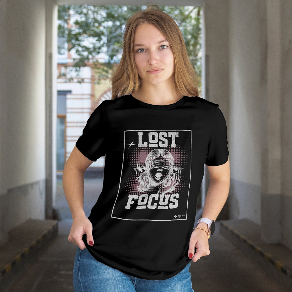 Person wearing a black t-shirt with 'Lost Focus' graphic design in an indoor setting.