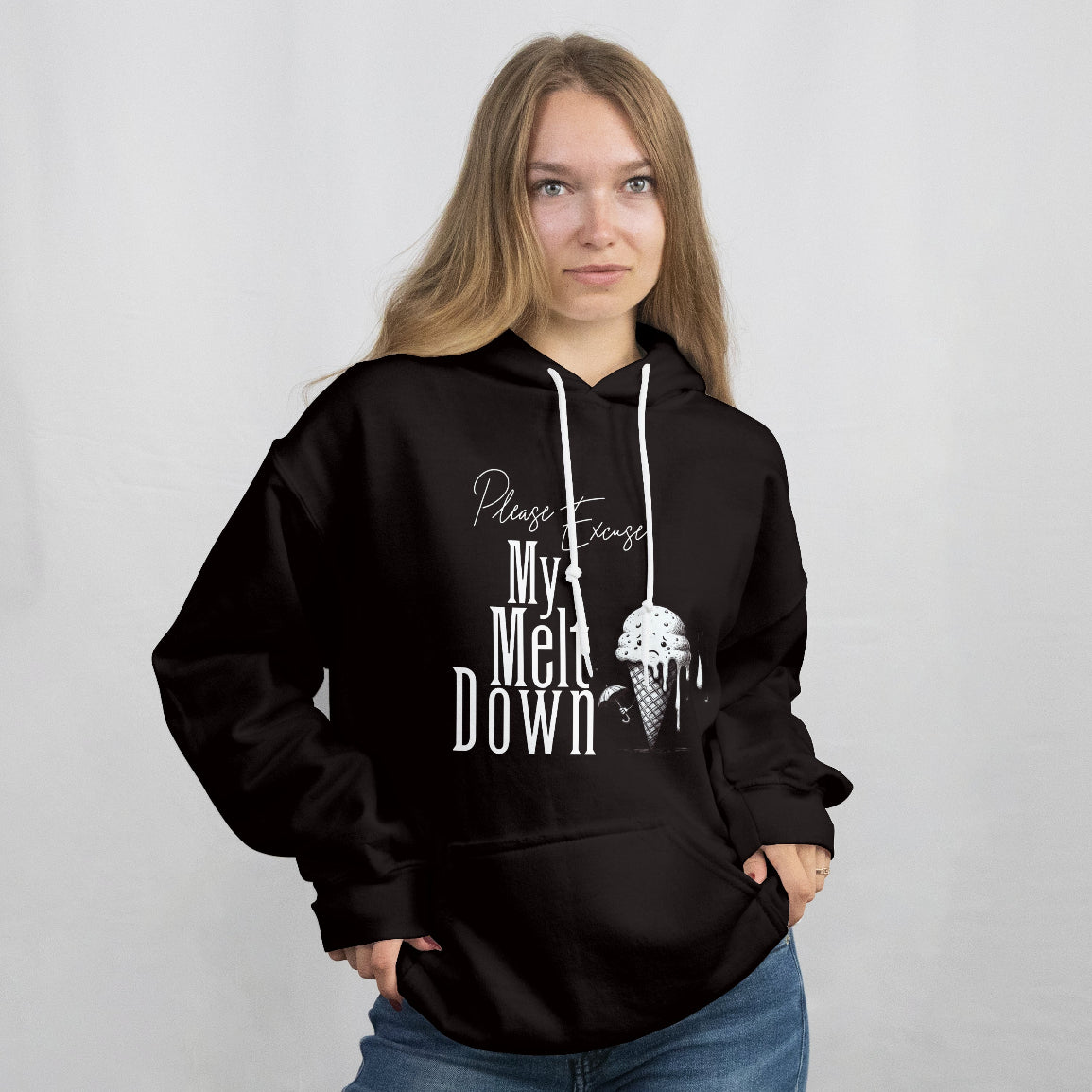 Young woman wearing a black hoodie with text and graphic design on a plain background