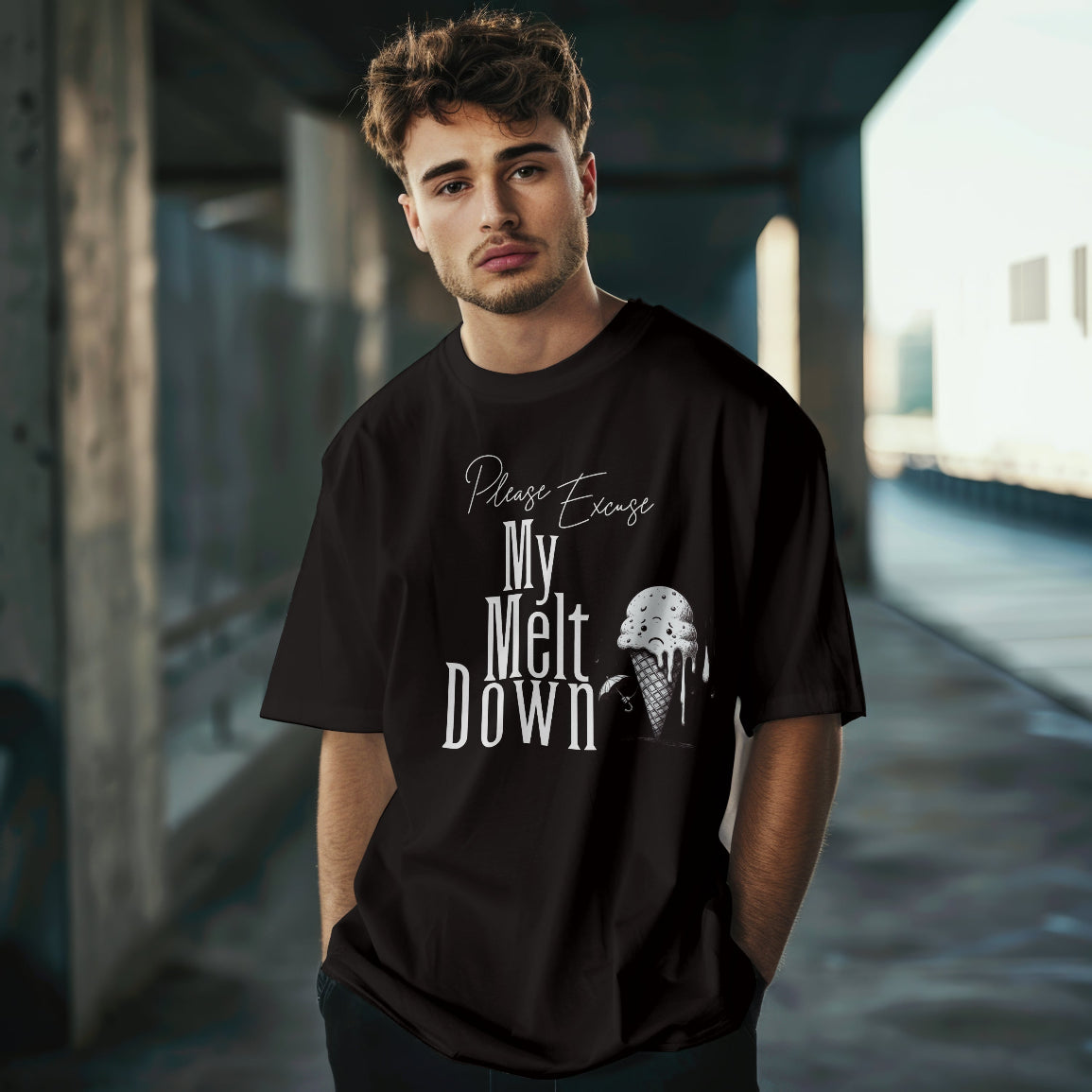 Young man wearing a black t-shirt with text and an ice cream graphic in an urban setting