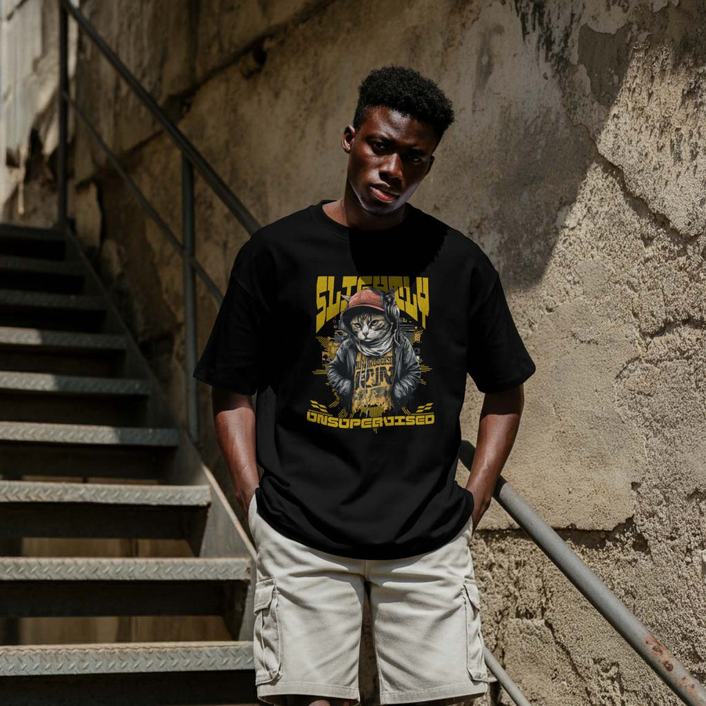 Person wearing a black t-shirt with a graphic design, standing on a staircase.
